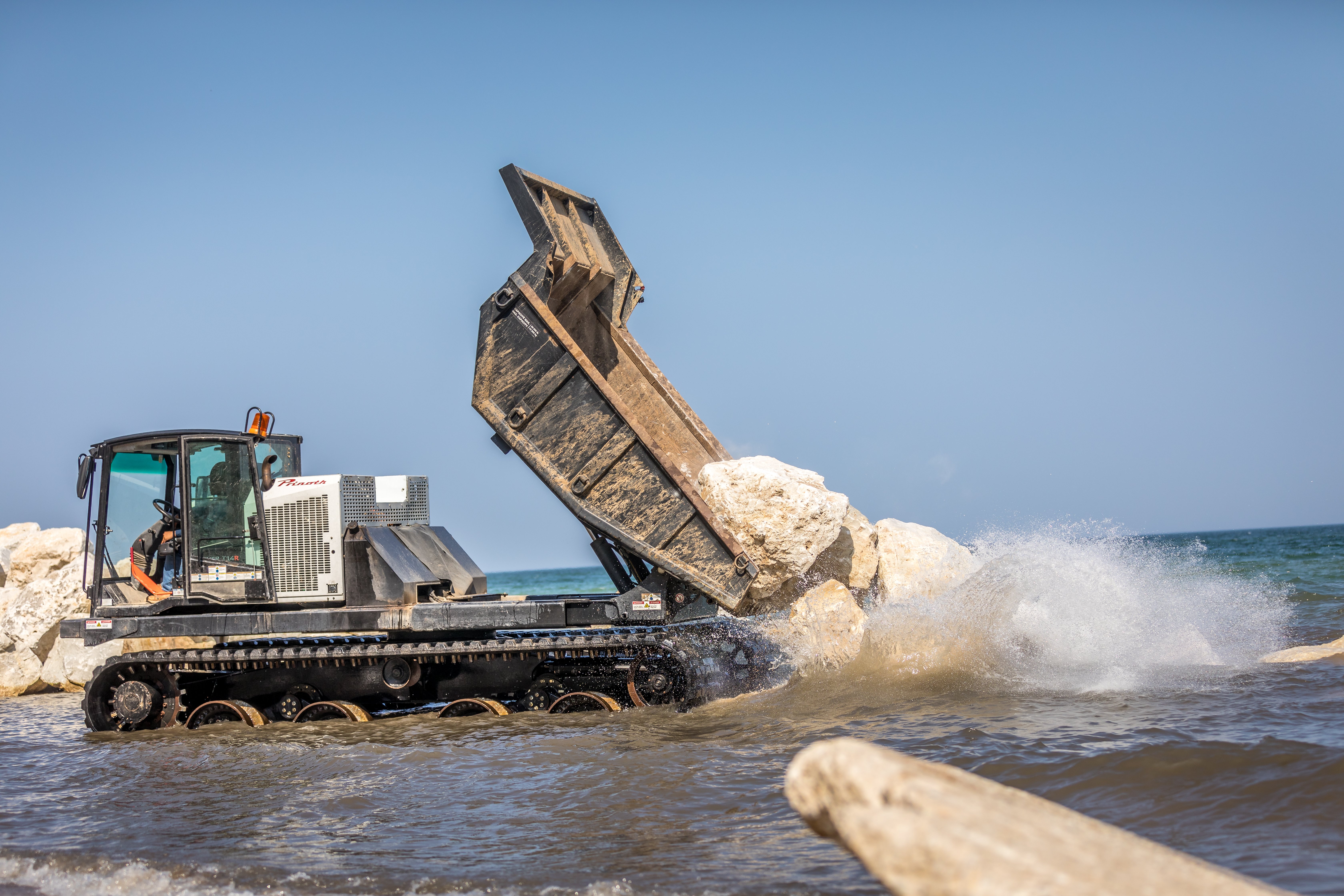 Homeowners along Lake Michigan had a necessity to safeguard their properties from excessive erosion. To address this issue, they employed a boulder erosion barrier as a solution.